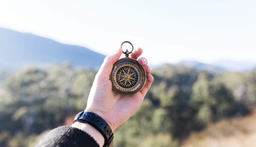 a compass in a hand
